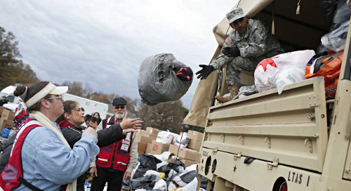 soldier helping citizens