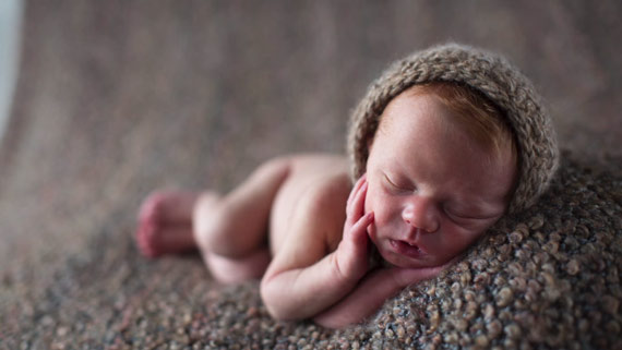 baby with a hat taking a nap