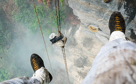 Collecting honey off of mountain