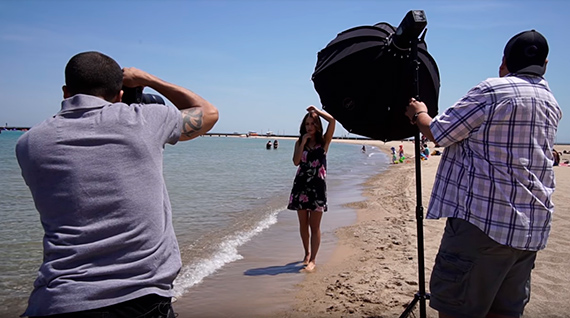 photographer and model shooting in sunlight with flash