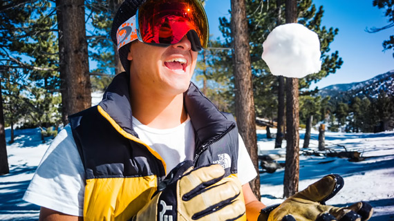 subject playing with snowball for portrait